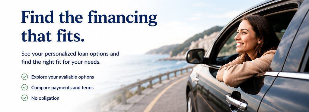 Find the financing. A smiling woman looking out her car window.